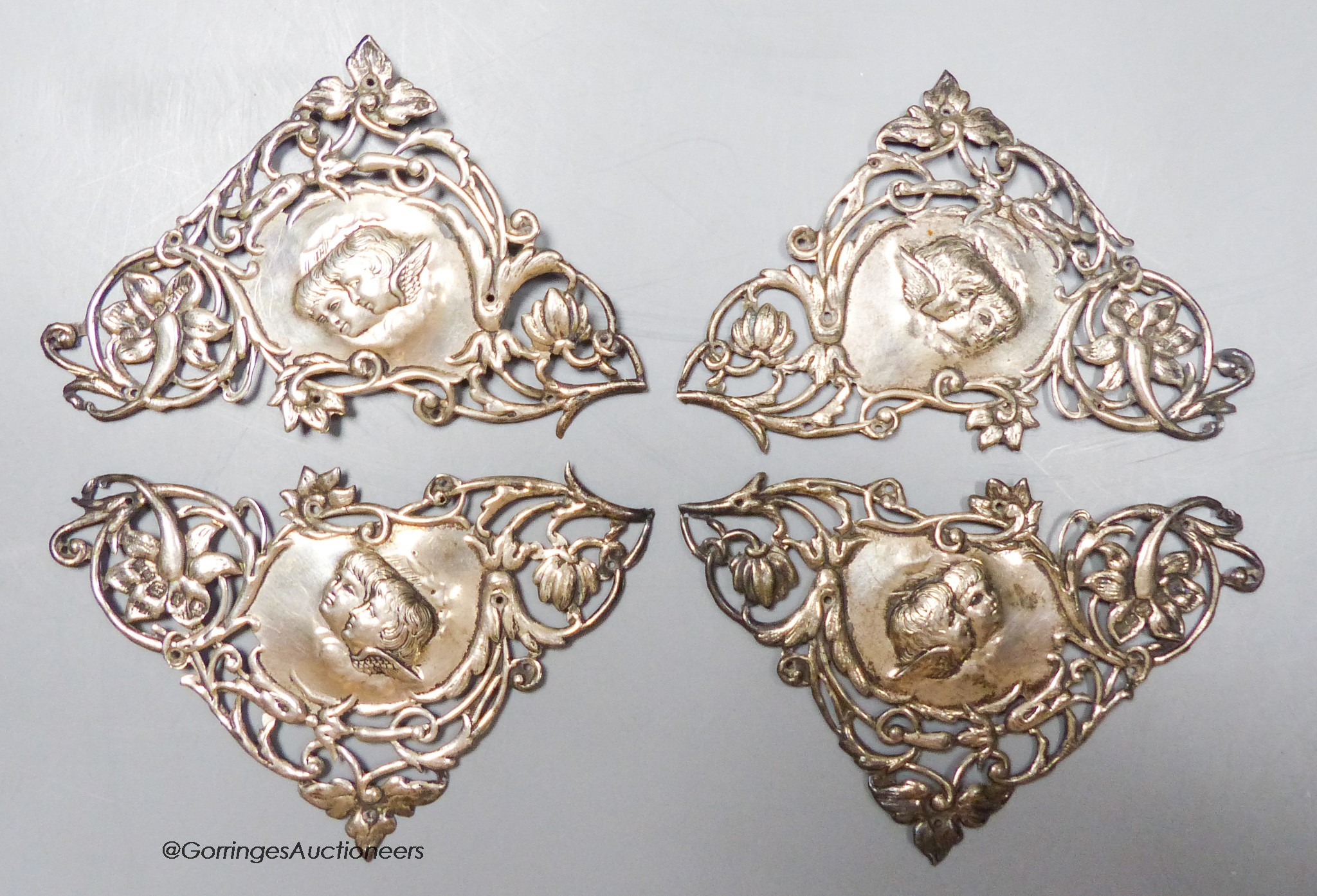 A set of four late Victorian pieced silver triangular mounts, decorated with Reynold's Angels, Henry Matthews, Birmingham, 1897, 94mm, 41 grams.